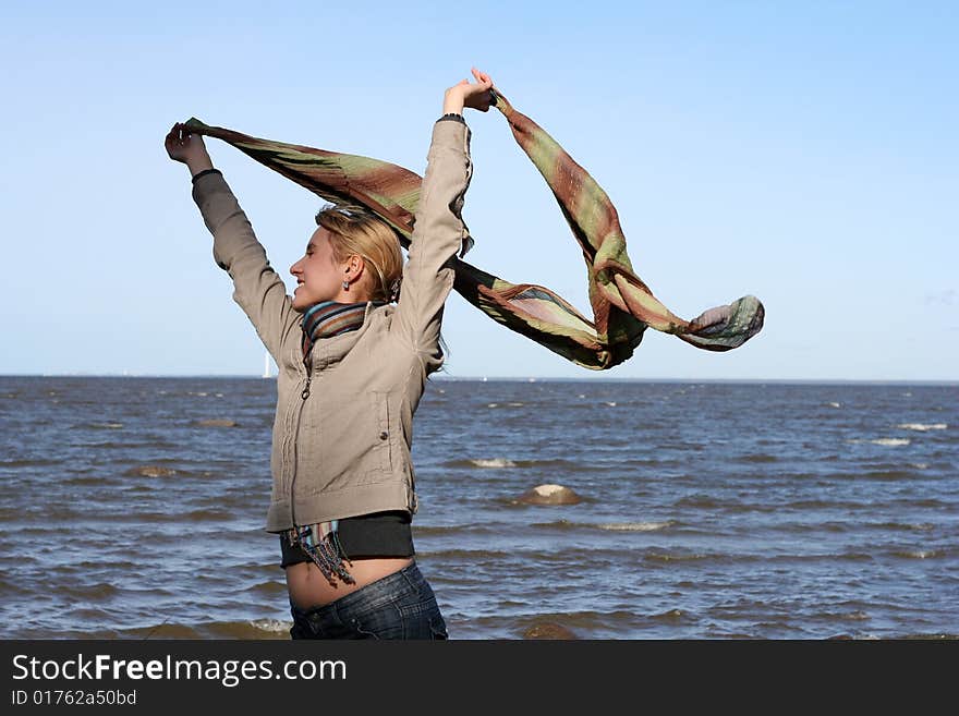 Blond woman with scarf. Windy day.