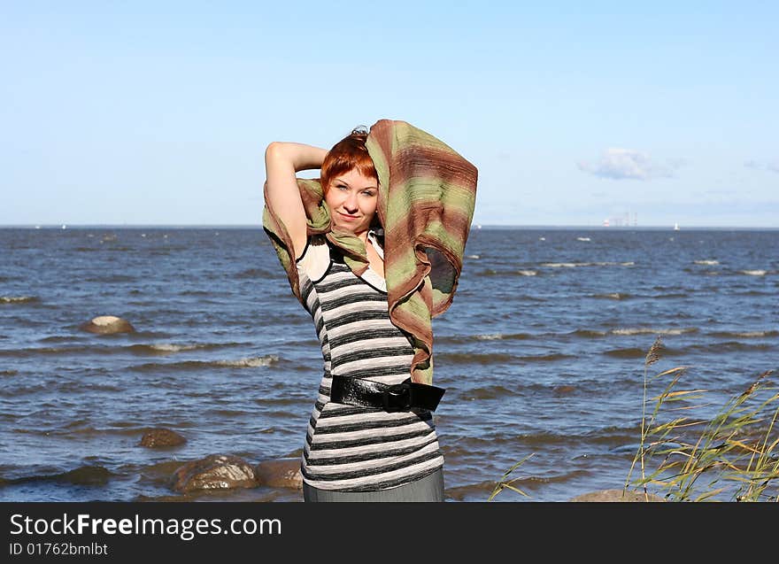 Red haired woman with scarf. Windy day.