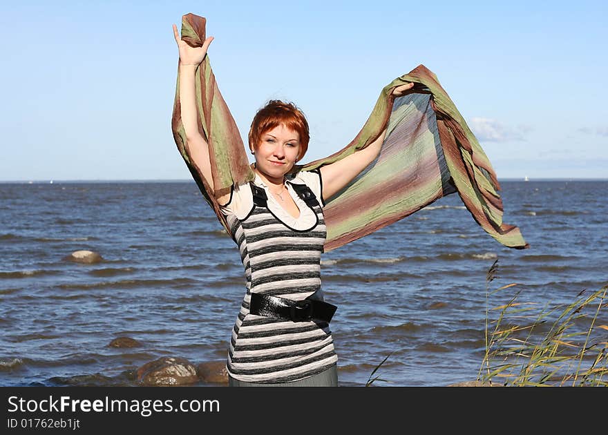 Red haired woman with scarf. Windy day.