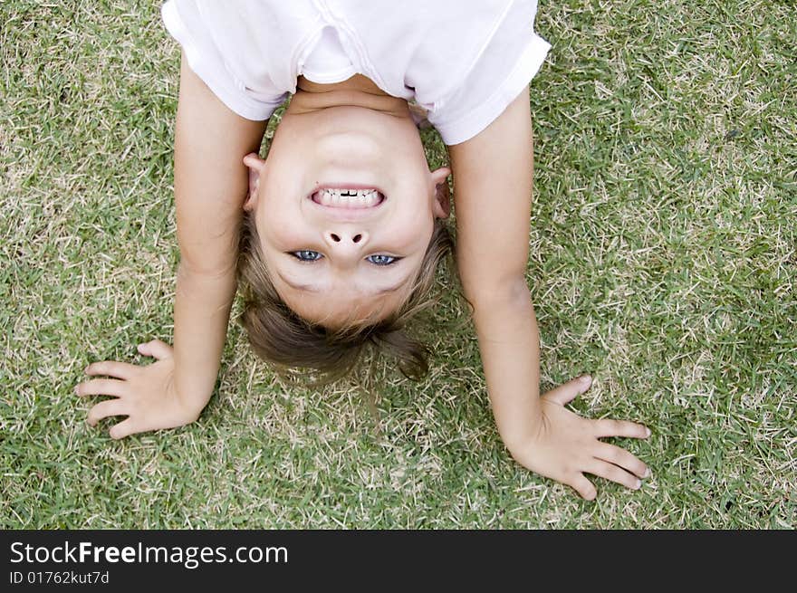 Girl Doing Cartwheel In The Grass