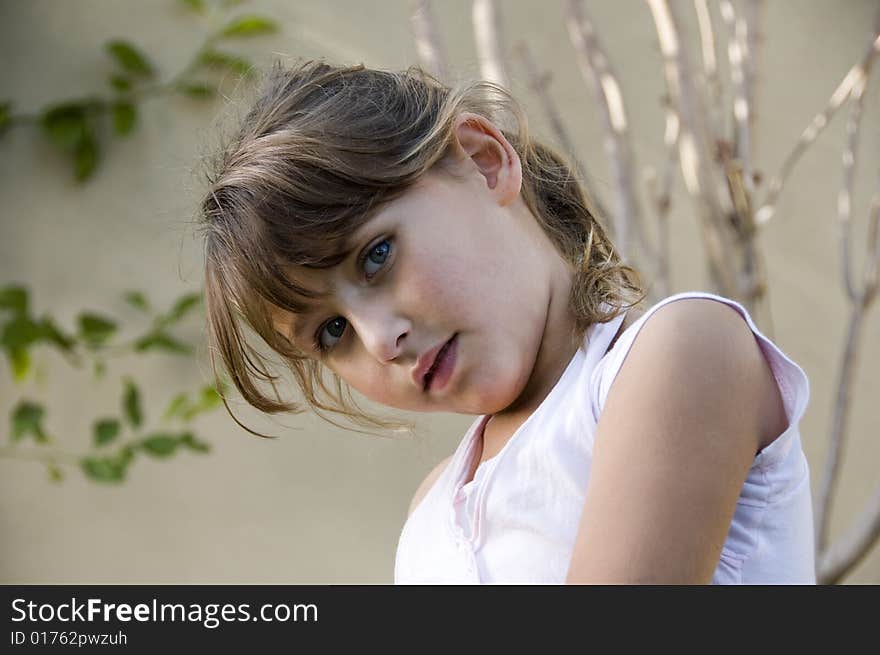 Adorable little girl posing in style on natural background