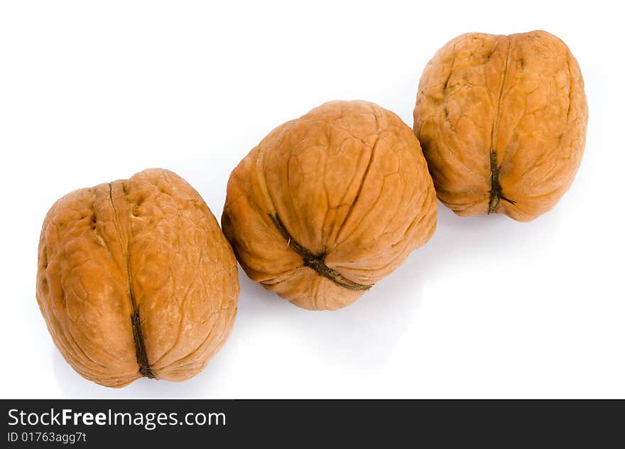 Three walnuts on white background