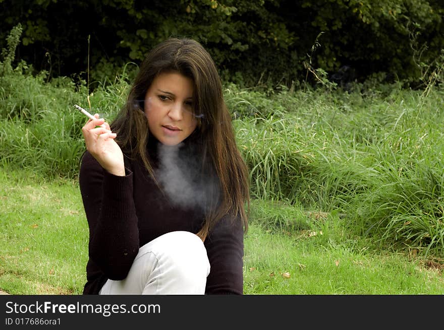 Young woman smoking looking depressed. Young woman smoking looking depressed.