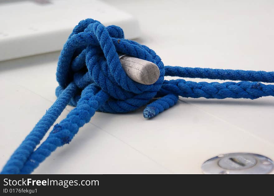 Blue rope with knot tied on a boat