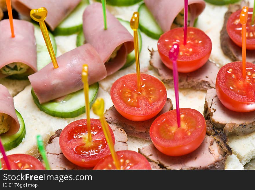 Canape tray closeup - meat, cucumber, ham, tomatoes