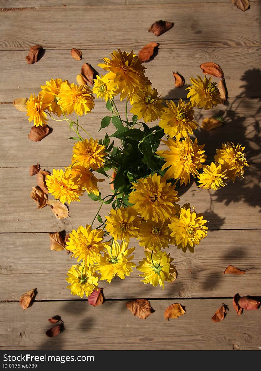 Autumn yellow flowers bouquet with dry leaves. Autumn yellow flowers bouquet with dry leaves