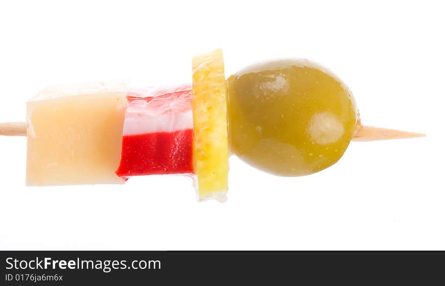 Close-up canape with olive, lemon, crab meat and cheese, isolated on white