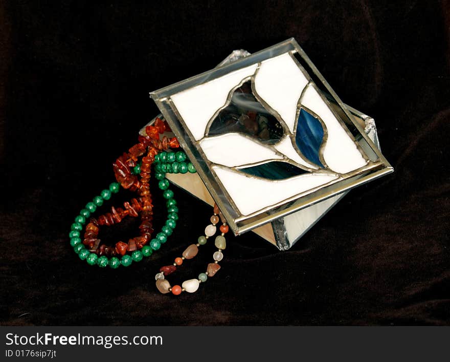 Necklaces of precious stones in the stained glass box. Necklaces of precious stones in the stained glass box