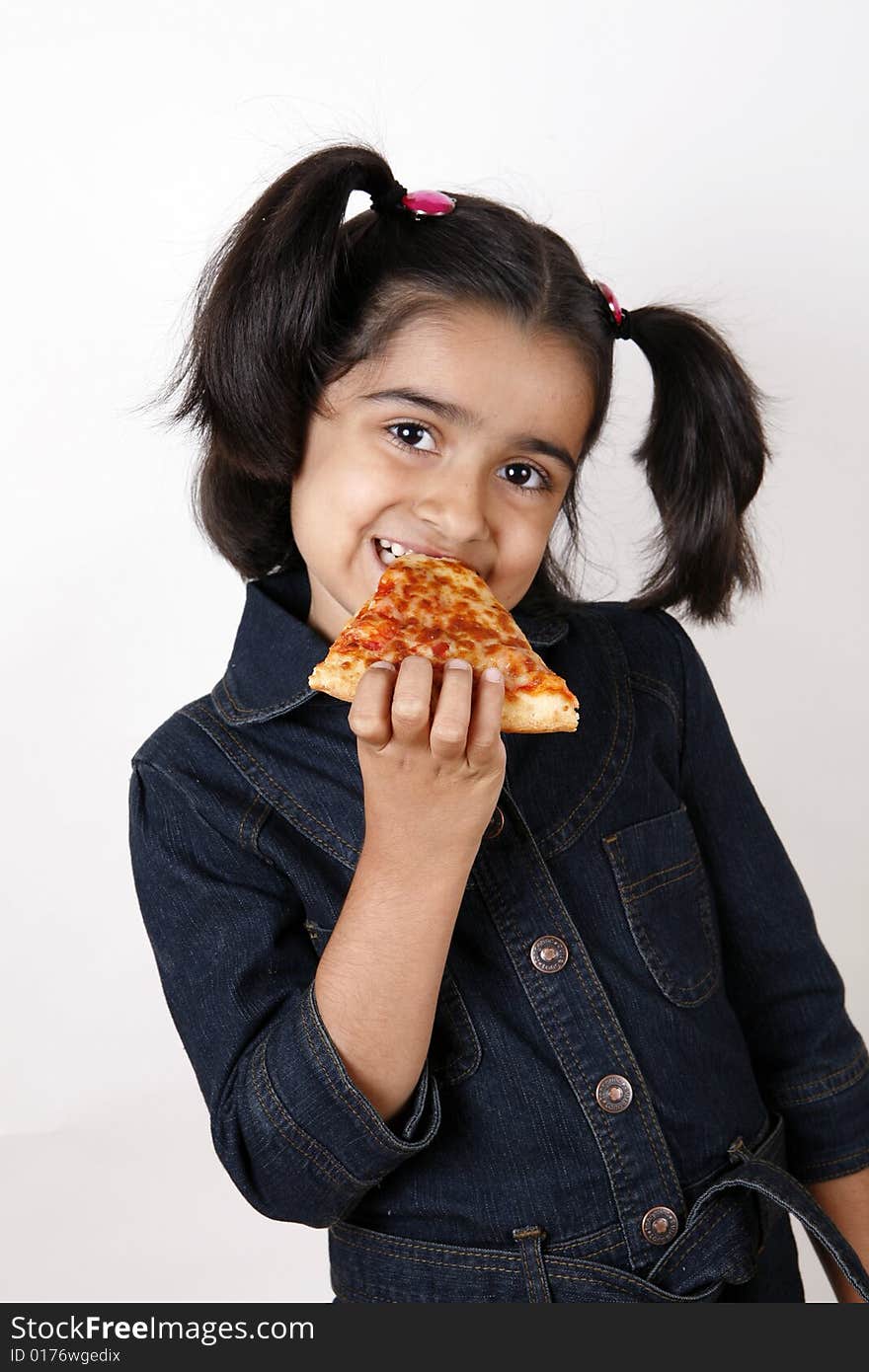 Girl eating pizza slice and smiling