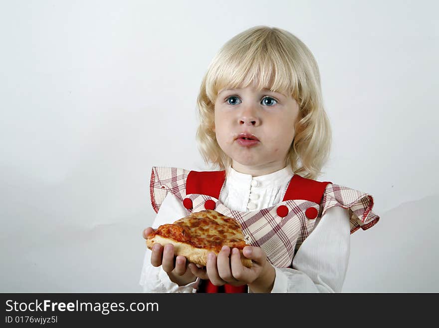 Sweet girl eating pizza slice