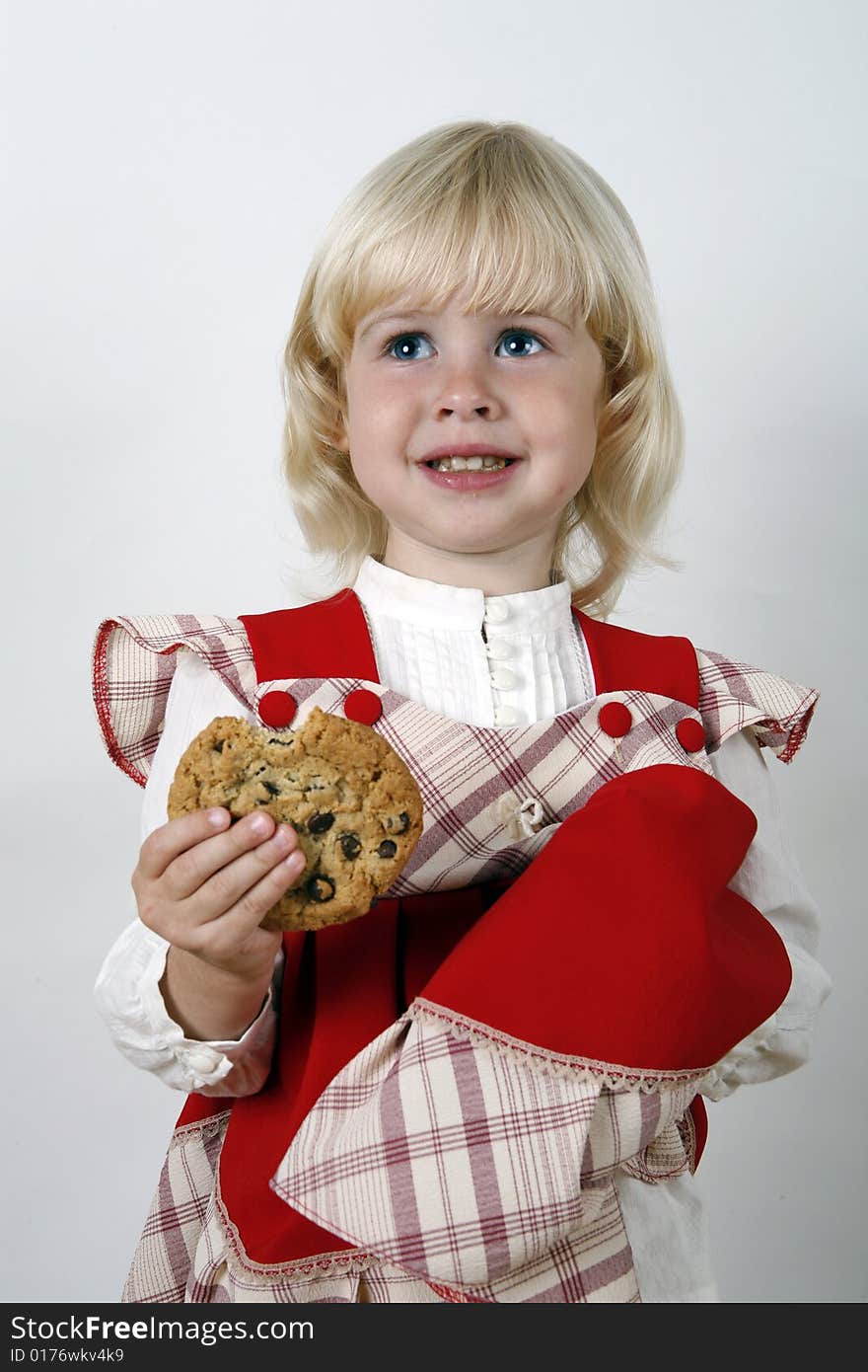 Sweet girl eating chocolate chip cookie. Sweet girl eating chocolate chip cookie