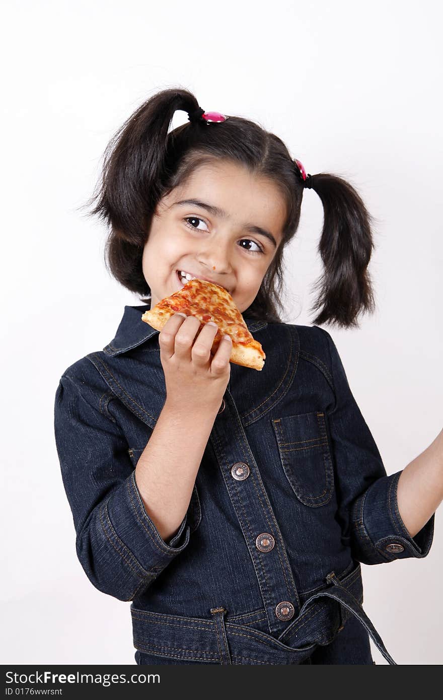 Girl eating pizza slice and smiling