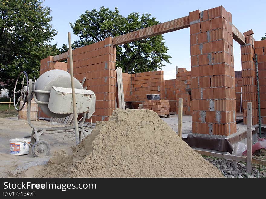 A brick layer putting down another row of bricks. A brick layer putting down another row of bricks