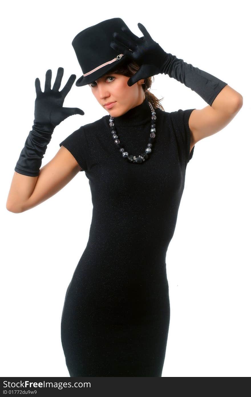 The girl in black clothes on a white background with a hat hat