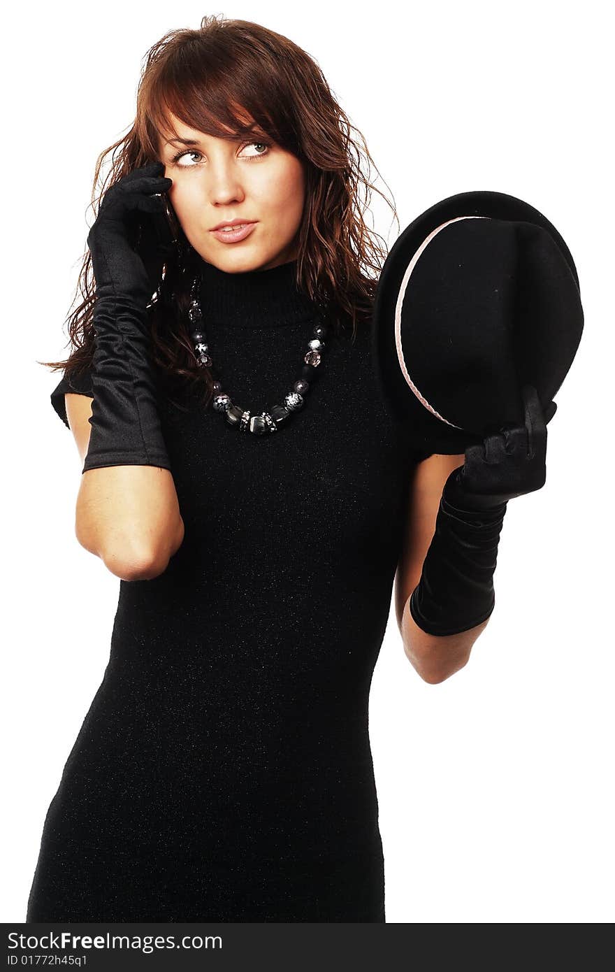 The girl in black clothes on a white background with a hat hat