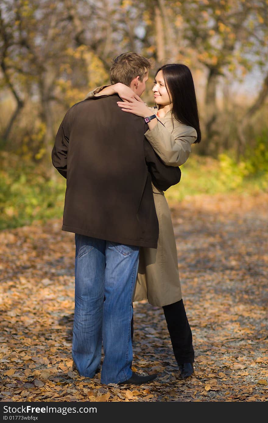 Young couple in love meeting in the autumn park