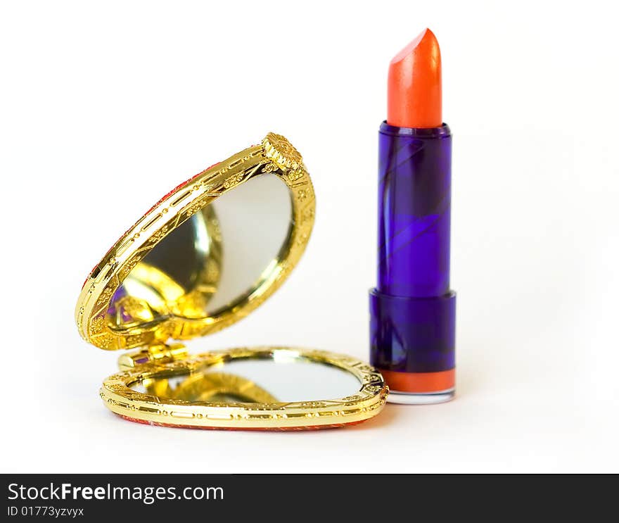 Heart shaped pocket mirror and red lipstick. Heart shaped pocket mirror and red lipstick