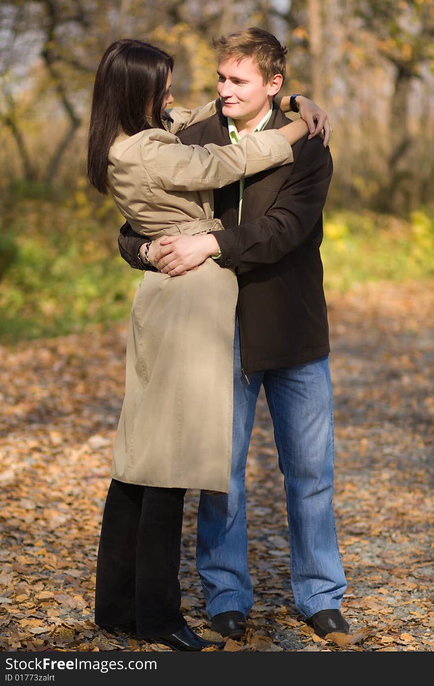 Young couple in love meeting in the autumn park