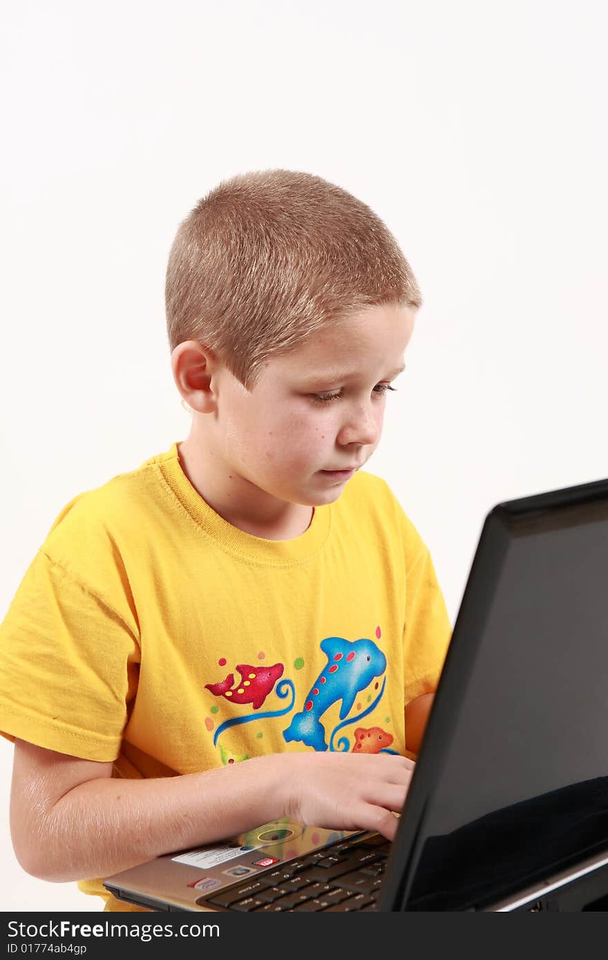 Young boy is working with his laptop - on white background. Young boy is working with his laptop - on white background