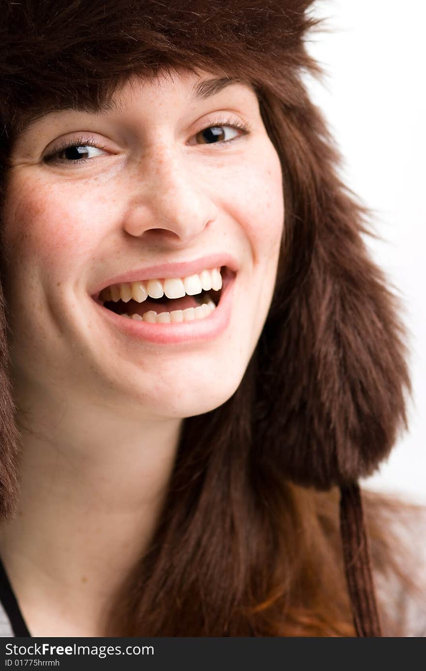 Woman, or teen in fall or winter hat smiling.