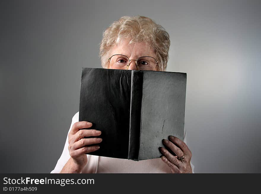 a senior woman with a book. a senior woman with a book