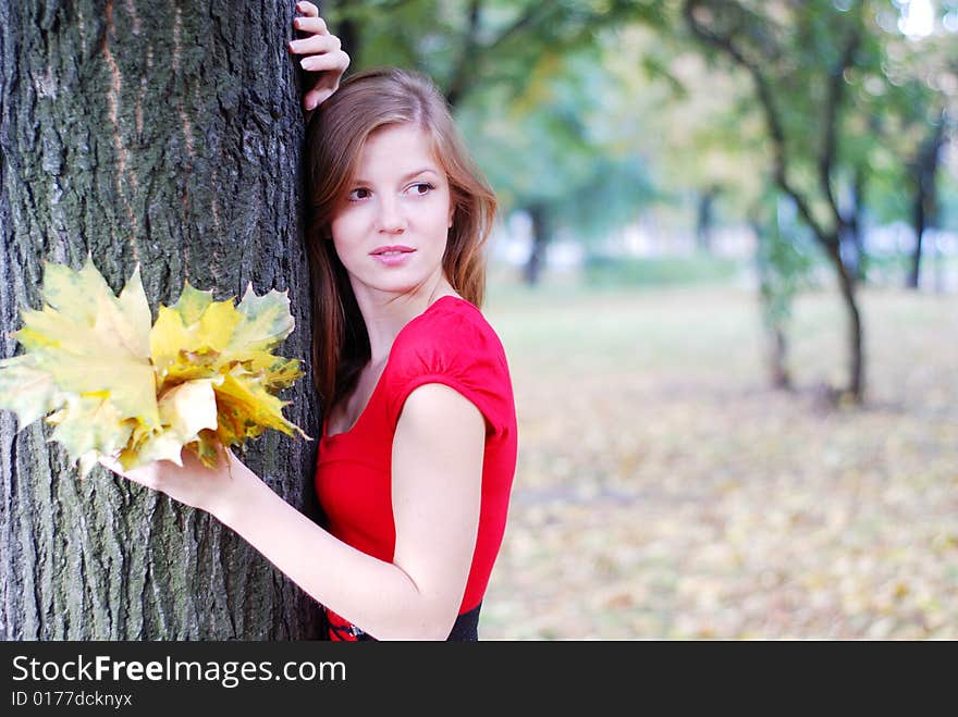 Woman with yellow  leaves