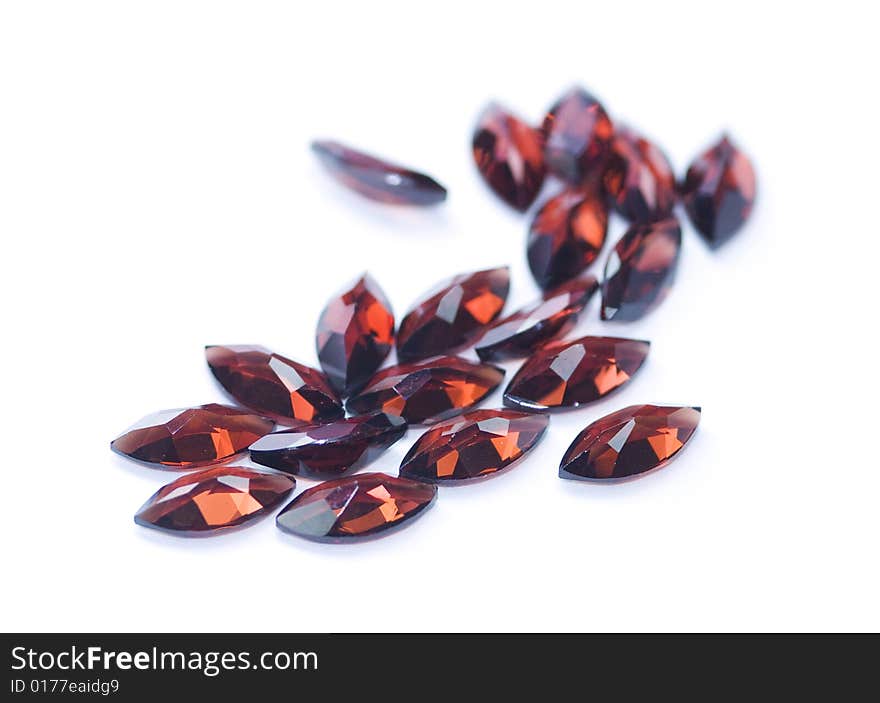 Garnets isolated on white background. Shallow depth of field with the nearest stones in focus.