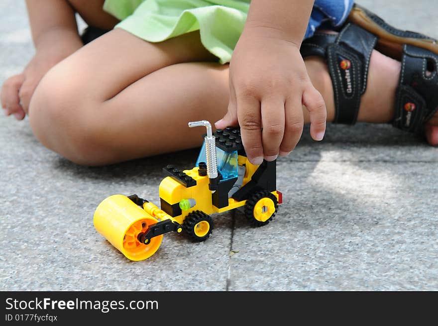 A  Boy Playing With A Toy Roller