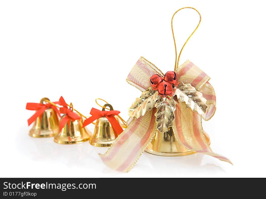 Gold christmas bells on a light background