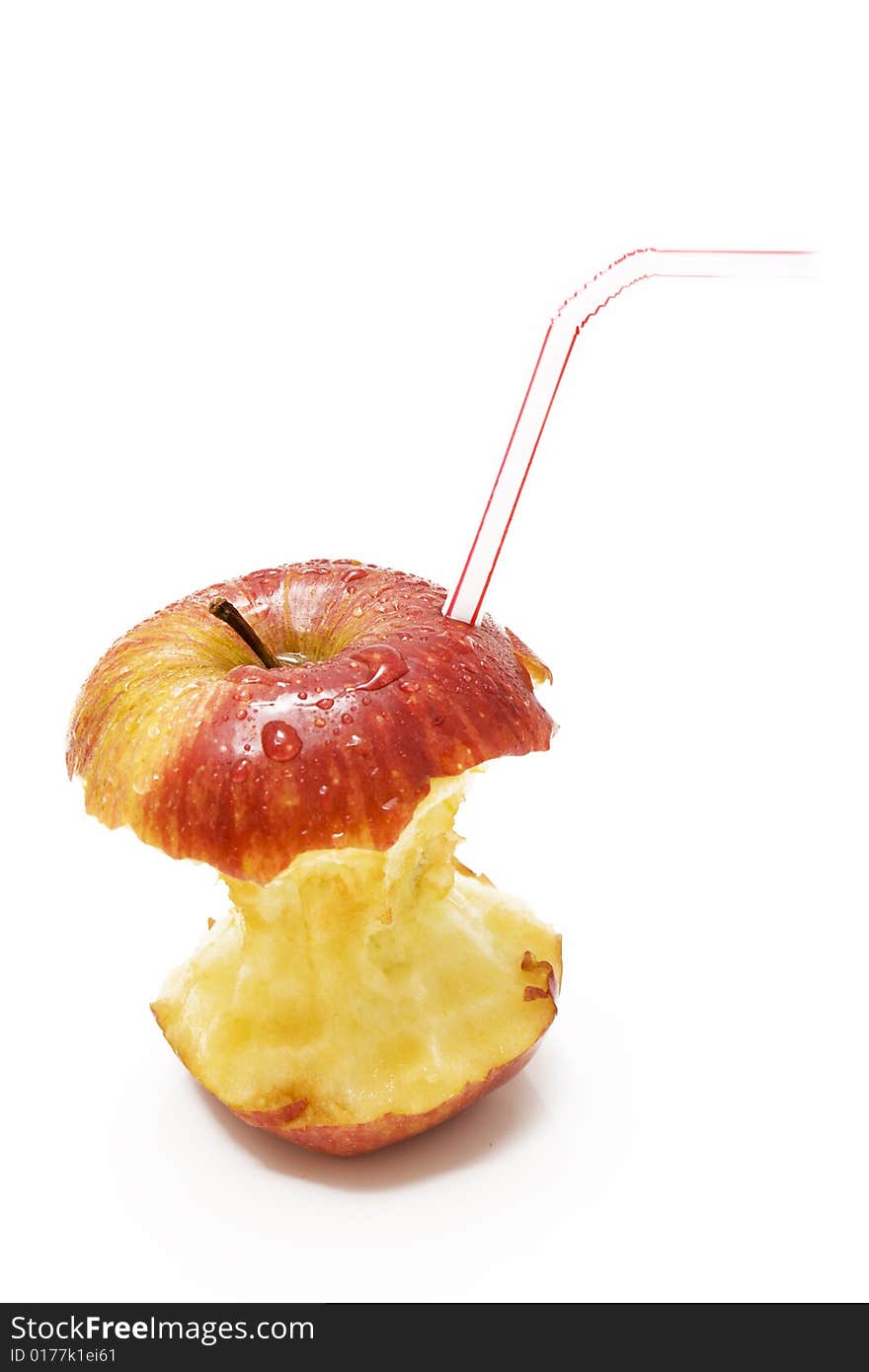 Isolated red apple stumb with drops and straw