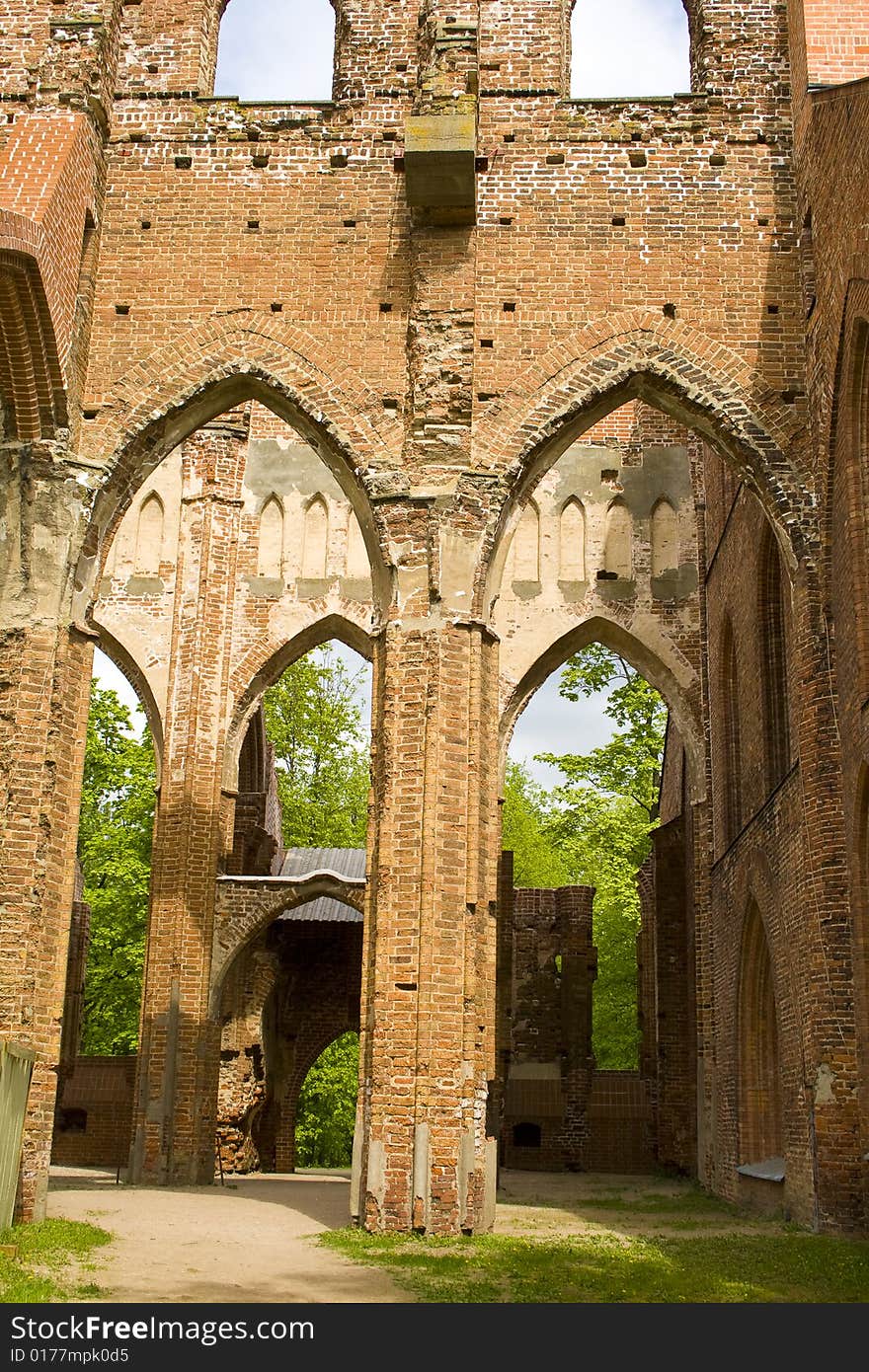 Ruined medieval castle in Latvia on a background of the blue sky