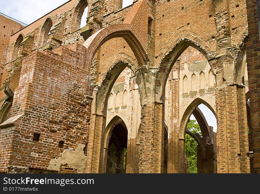 Ruined medieval castle in Latvia on a background of the blue sky