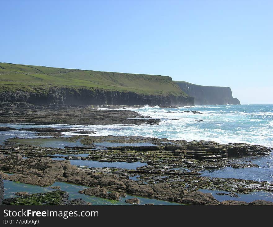 A lush coastal shore on a clear day. A lush coastal shore on a clear day.