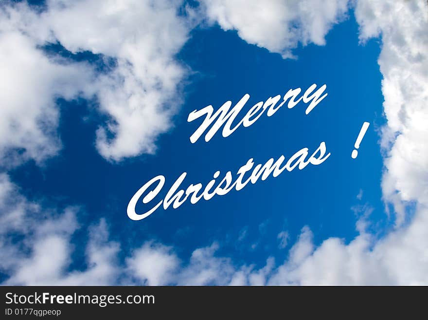 Merry Christmas inscription at the cloudy sky