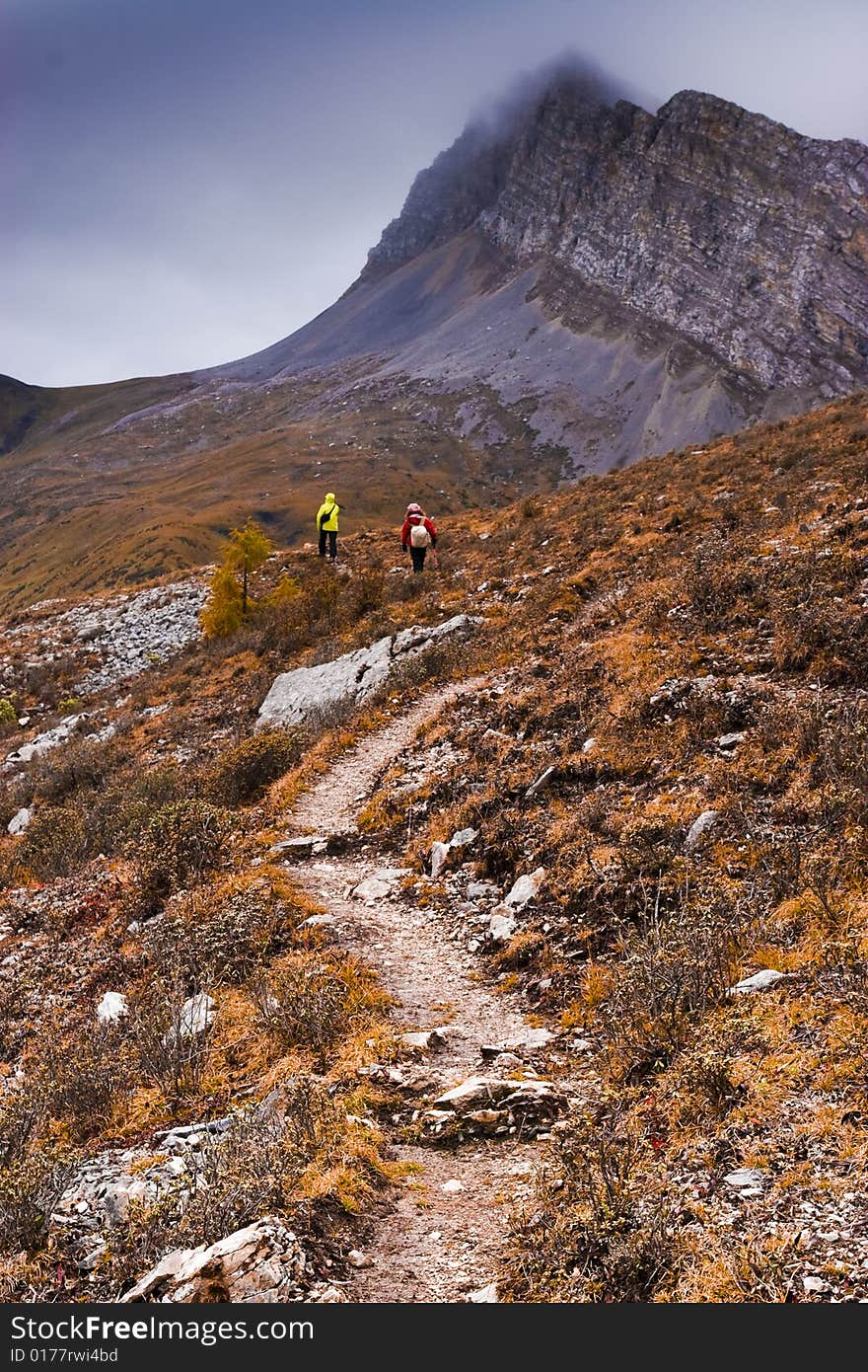 There are some people climbing Mountains. There are some people climbing Mountains