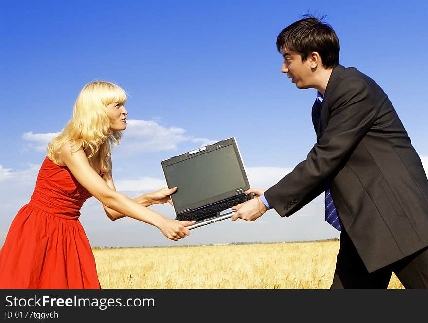 Businessman and lady in red fighting for notebook. Businessman and lady in red fighting for notebook