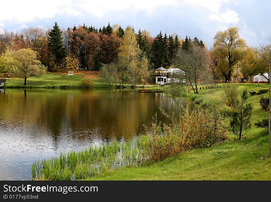 Beautiful lake with bridge in the autumn park