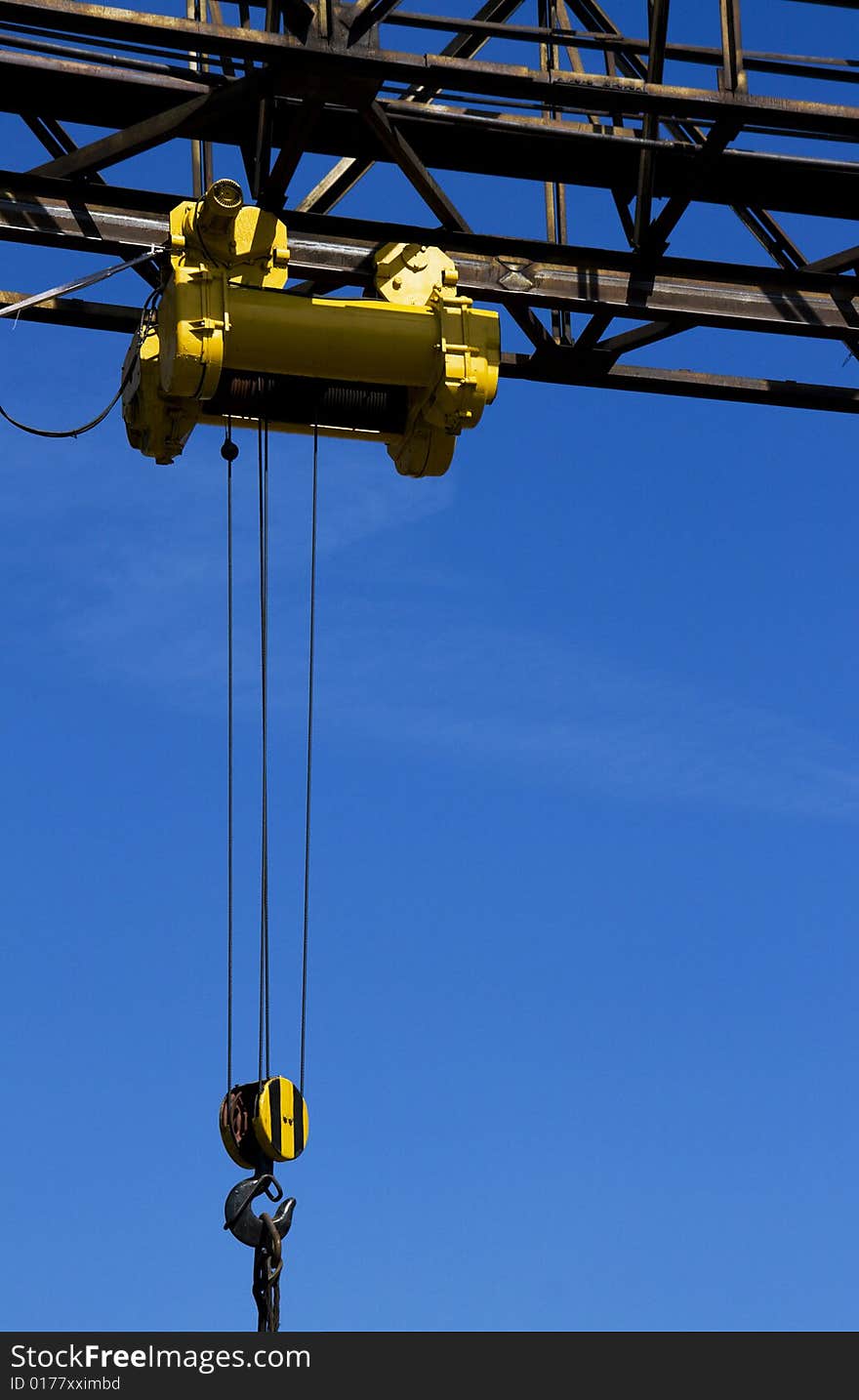 Gantry with hook over blue sky