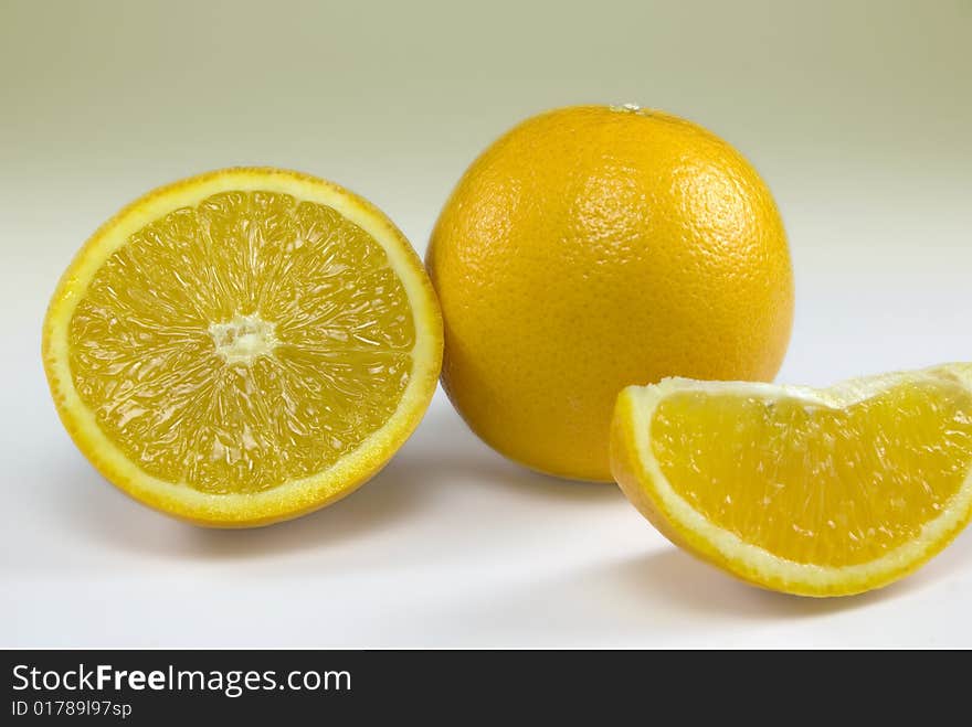 Orange and orange slices isolated on a plain background. Orange and orange slices isolated on a plain background