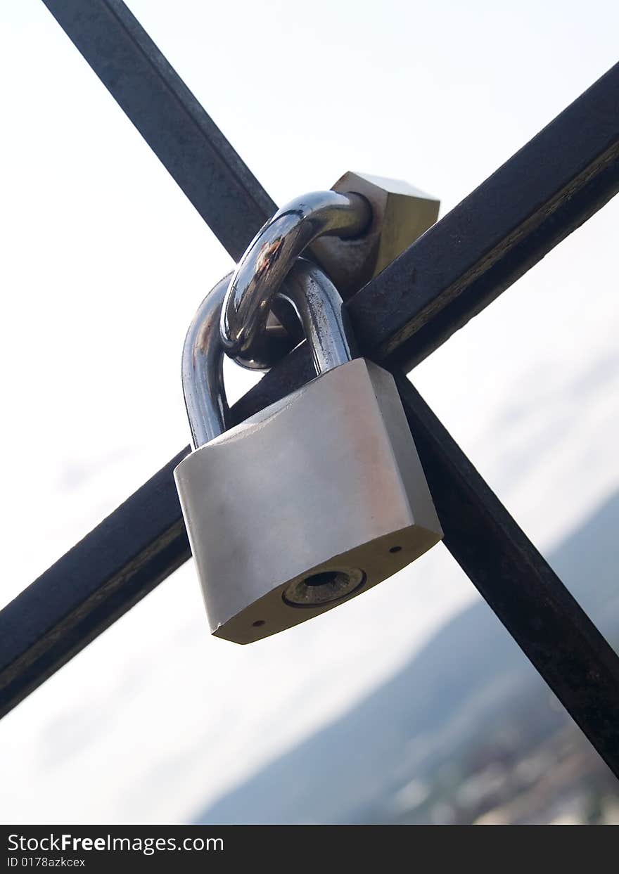 Two steel padlocks locked together. Two steel padlocks locked together