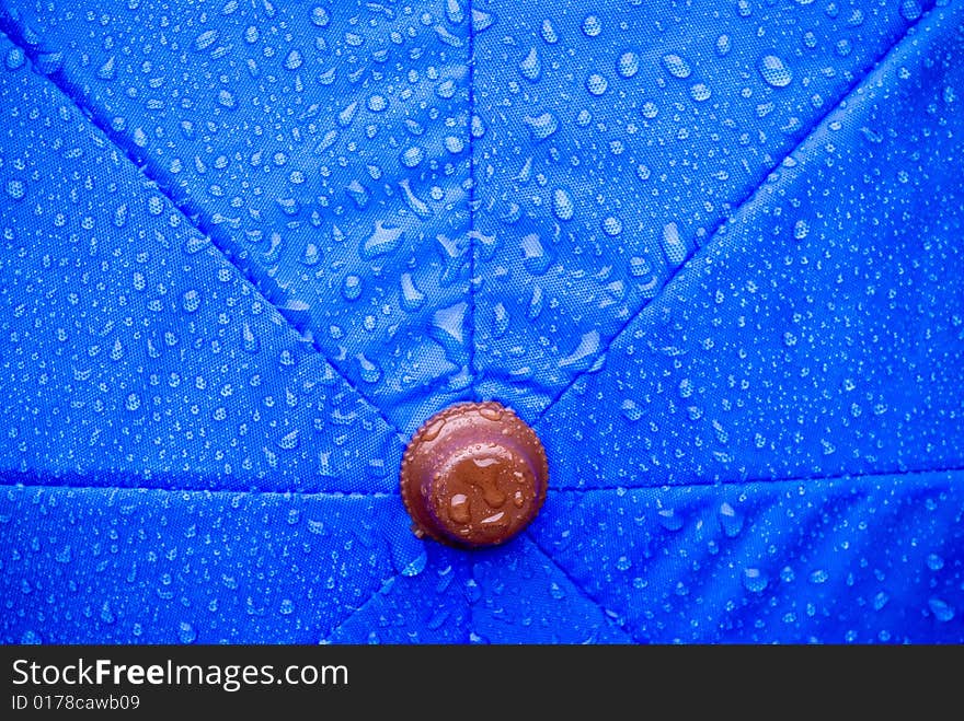 A closeup of a wet blue unmbrella. A closeup of a wet blue unmbrella