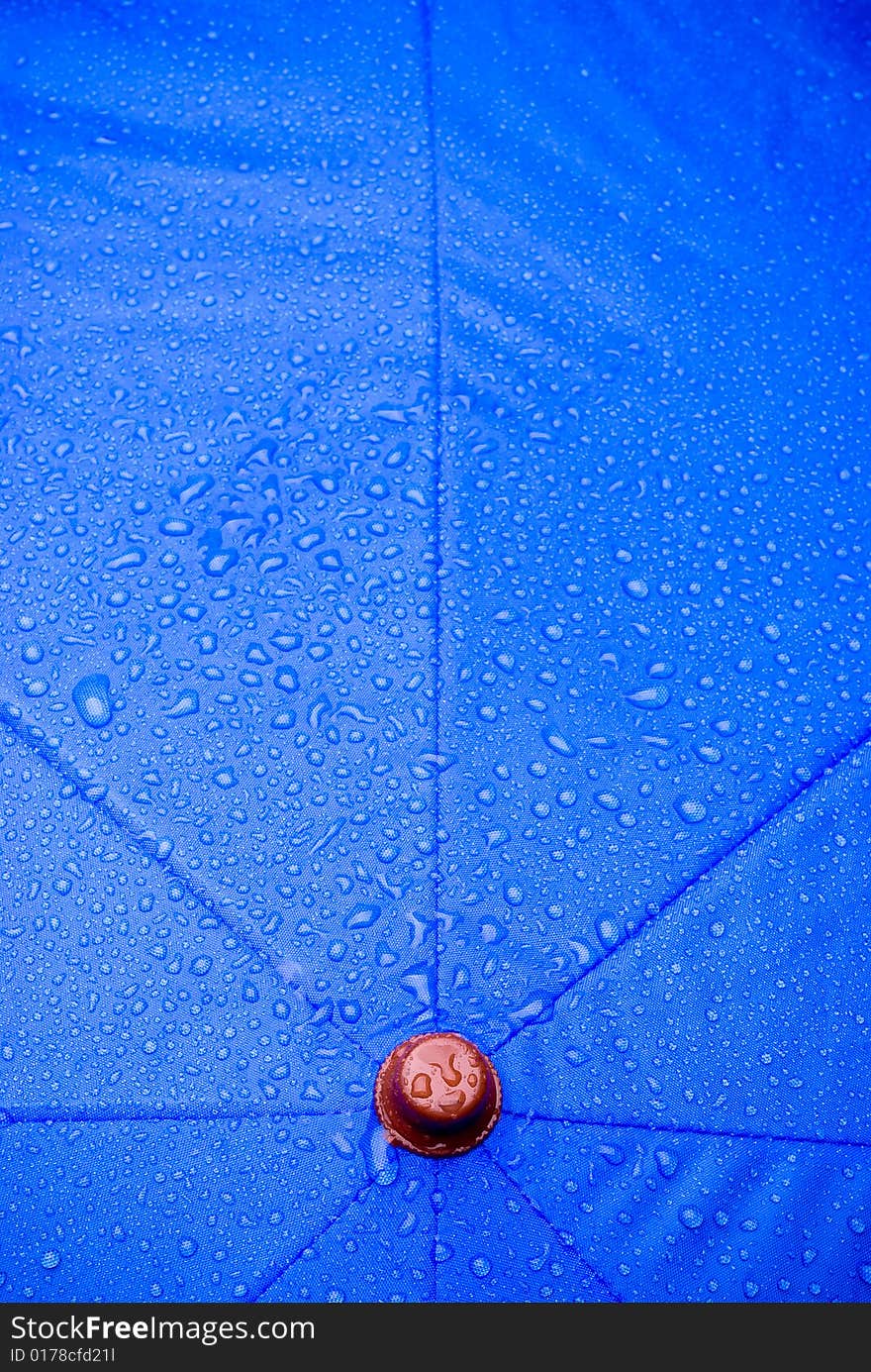 A closeup of a wet blue unmbrella. A closeup of a wet blue unmbrella