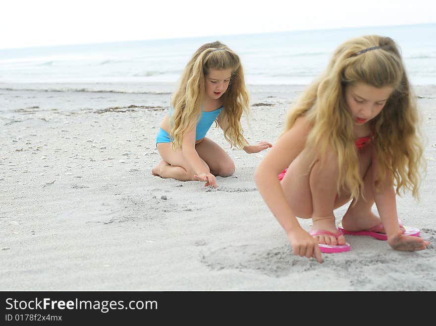 Shot of sisters in the sand