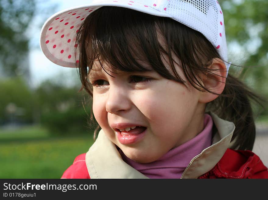 Offended and crying little girl in the park