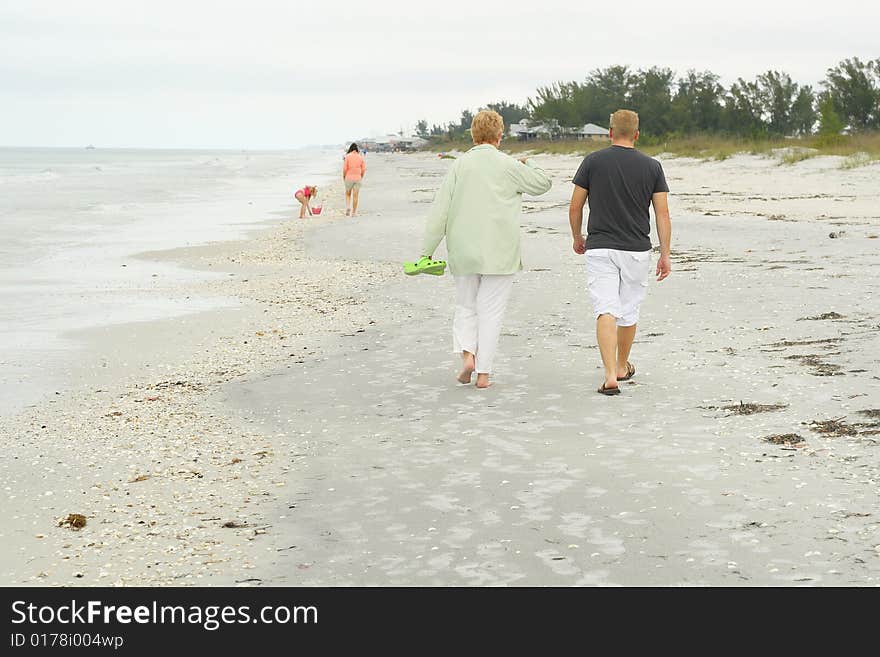 Shot of people walkin on the beach