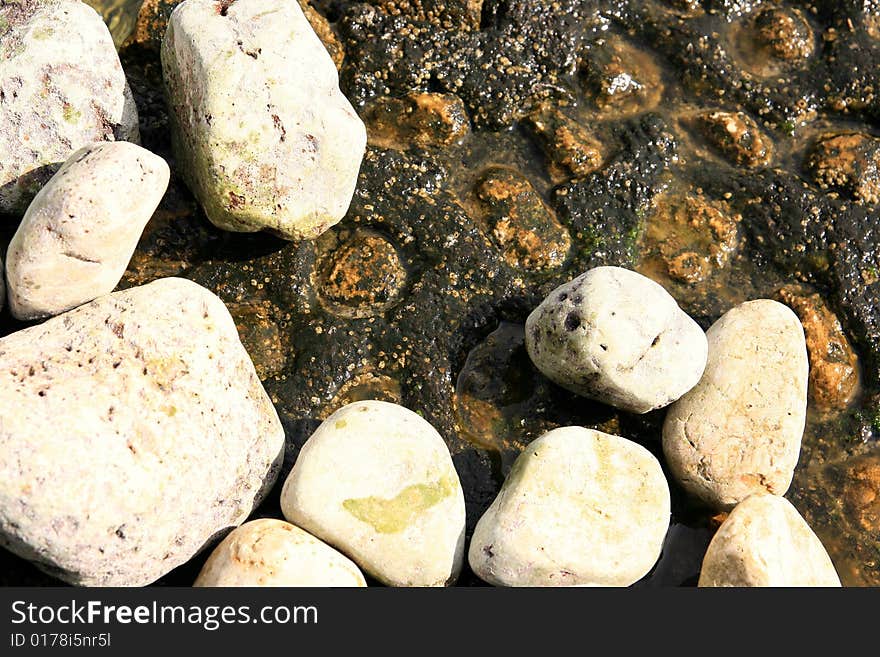 Stones on the rock marine background