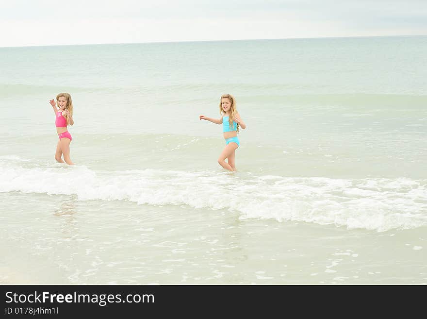 Shot of twin sisters at the beach