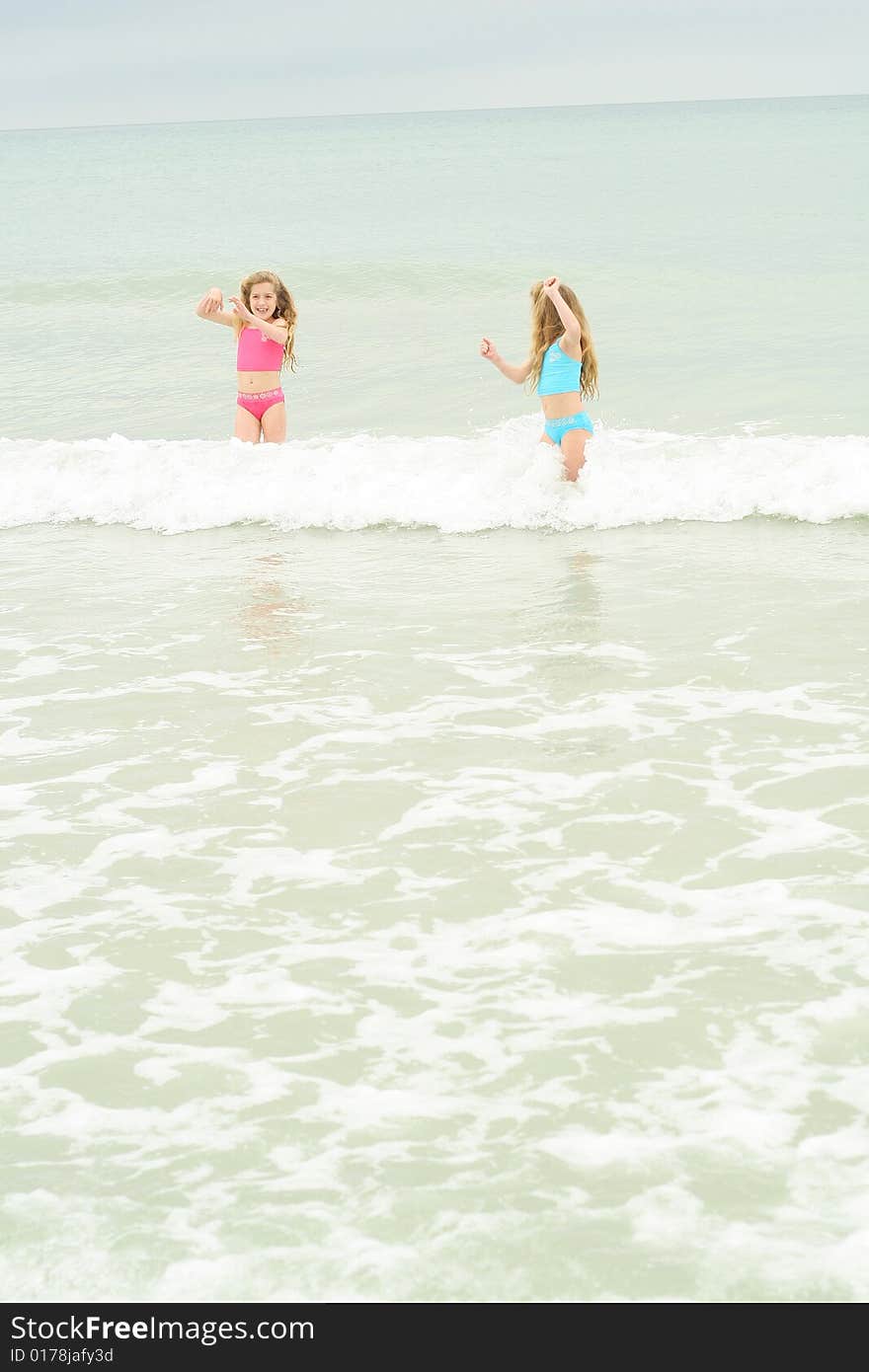 Sisters Running From The Waves Vertical