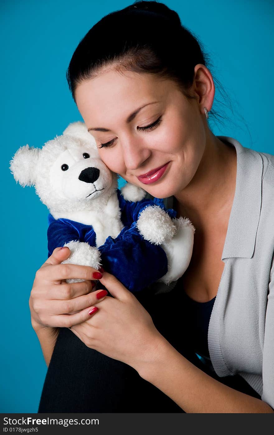 The beautiful girl with a toy bear. The beautiful girl with a toy bear