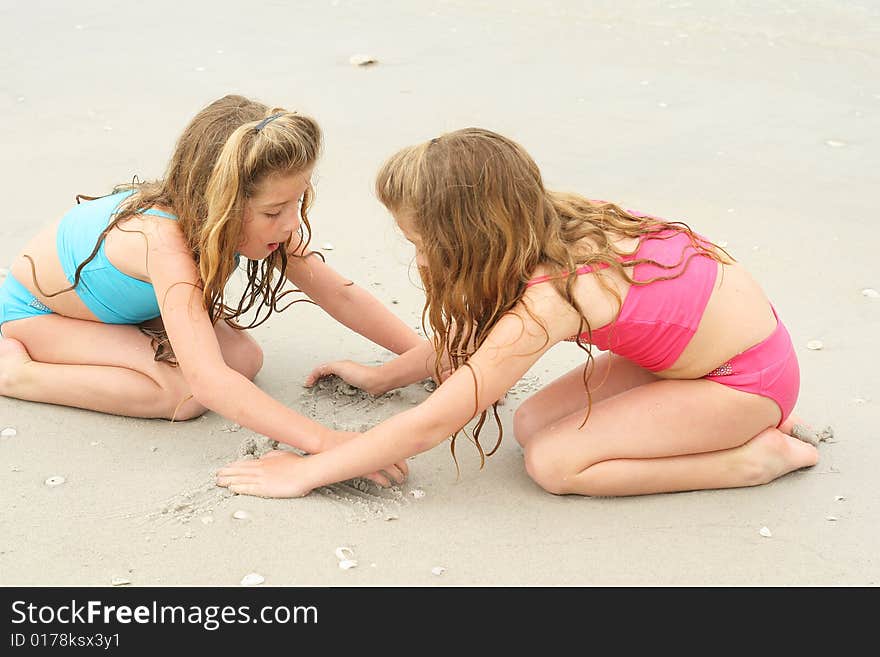 Shot of sisters sharing the sand